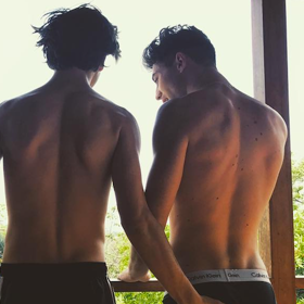 Boybander gives fans an eye-full while on vacation with model boyfriend