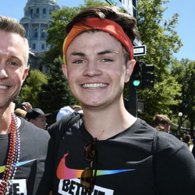 Gay coach and his gay teen son march together at Pride