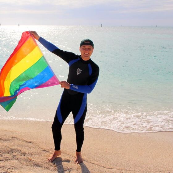 This sexy travel guru lives in a van and is literally planting the rainbow flag everywhere he goes