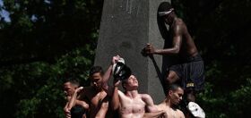PHOTOS: Lubed up plebes continue annual tradition of scaling giant stone phallus