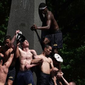 PHOTOS: Lubed up plebes continue annual tradition of scaling giant stone phallus