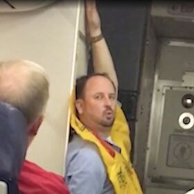Watch this sassy flight attendant perform a seductive pre-flight ‘striptease’