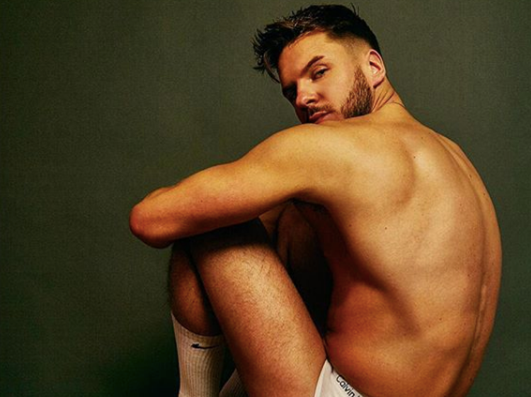 Reality star says having gay relationship unfold on screen was “difficult and awkward”