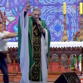 Woman shoves mega-famous anti-gay priest offstage in front of 50,000 praying Catholics