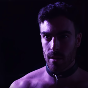 WATCH: Mike Taveira wears a singlet and gets slapped with a leather crop to satisfy his curiosities