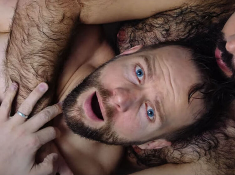 Tom Goss lathers up with a hairy hunk in his latest music video