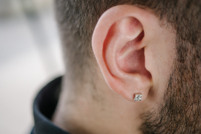 Earring in a male ear.