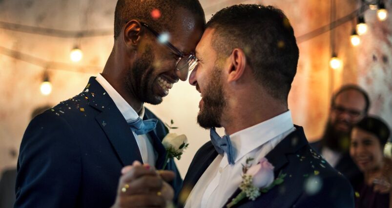 Two grrooms dance at their same-sex wedding ceremony