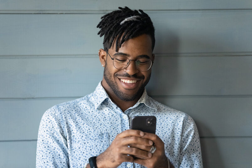 Man looking at something funny on his smart phone