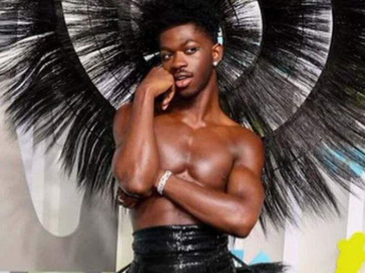Lil Nas X wows red carpet with topless, feathered hoop dress
