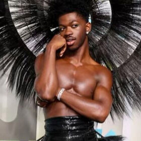 Lil Nas X wows red carpet with topless, feathered hoop dress