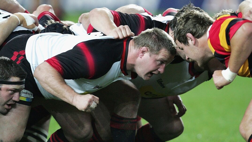 Rugby player Campbell Johnstone in a scrum.