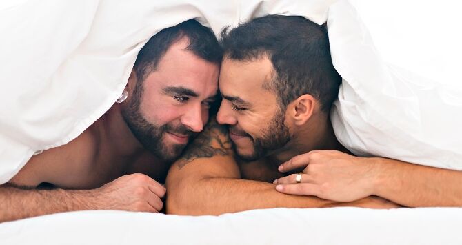 Two men in bed together
