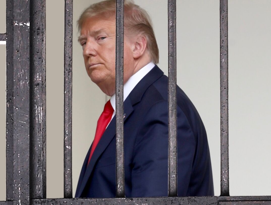 A graphic of Donald Trump standing behind fake prison bars.