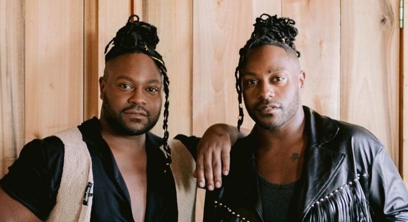 The Campbell twins of the Kentucky Gentlemen band wearing their head in braids.