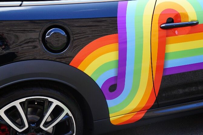A car decorated with a rainbow pride design