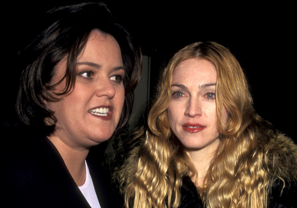A paparazzi photo of Rosie O'Donnell and Madonna standing next to each other at an event, both wearing black.
