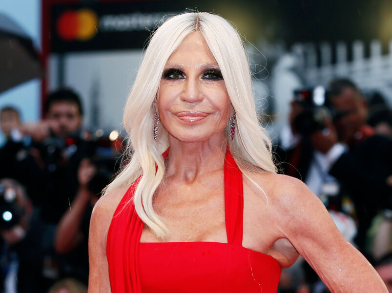 Donatella Versace in a red dress on the red carpet