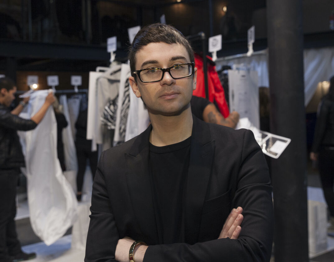 Christian Siriano wearing a black jacket in his studio