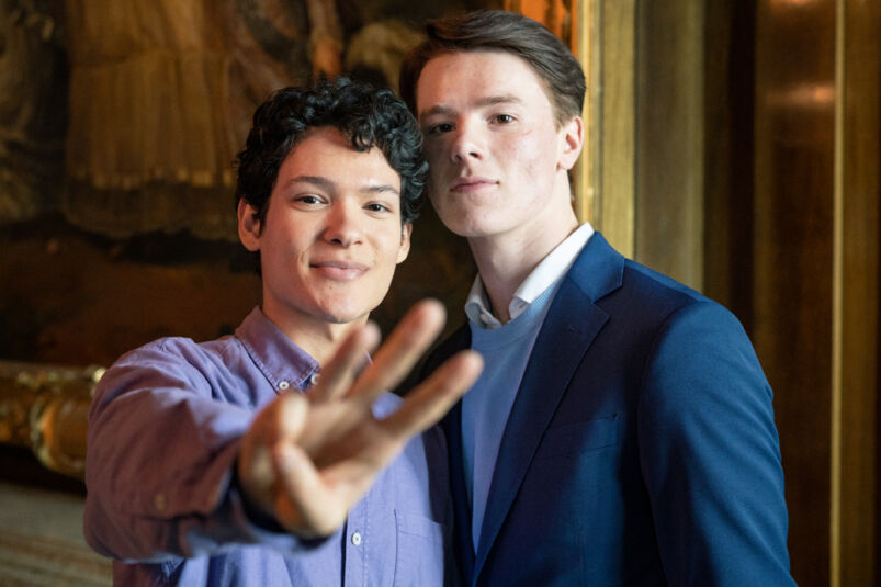 'Young Royals' stars Omar Rudberg and Edvin Ryding pose for the camera on set.