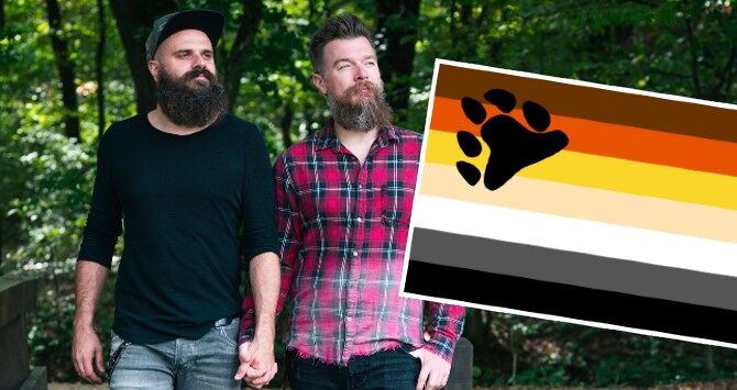 Two bearded men hold hands, alongside a bear pride flag