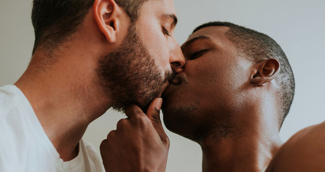 Two men kiss - a gay couple kiss