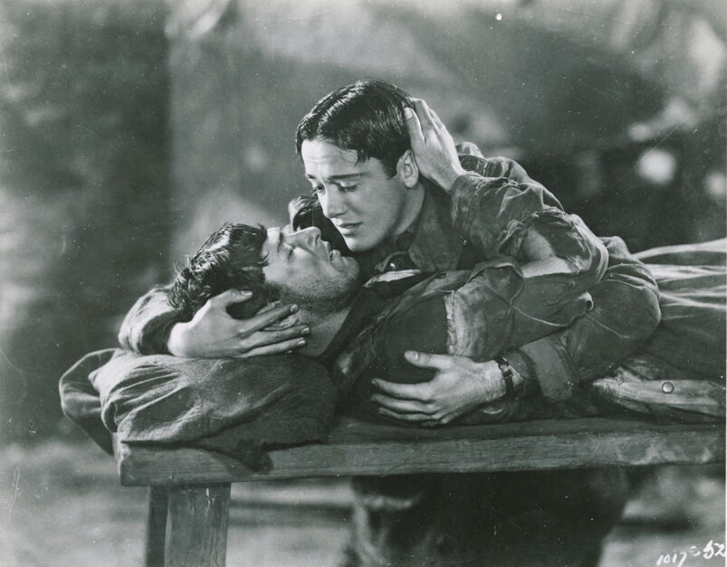 Charles (Buddy) Rogers holds and comforts Richard Arlen on his deathbed in a scene from the movie Wings