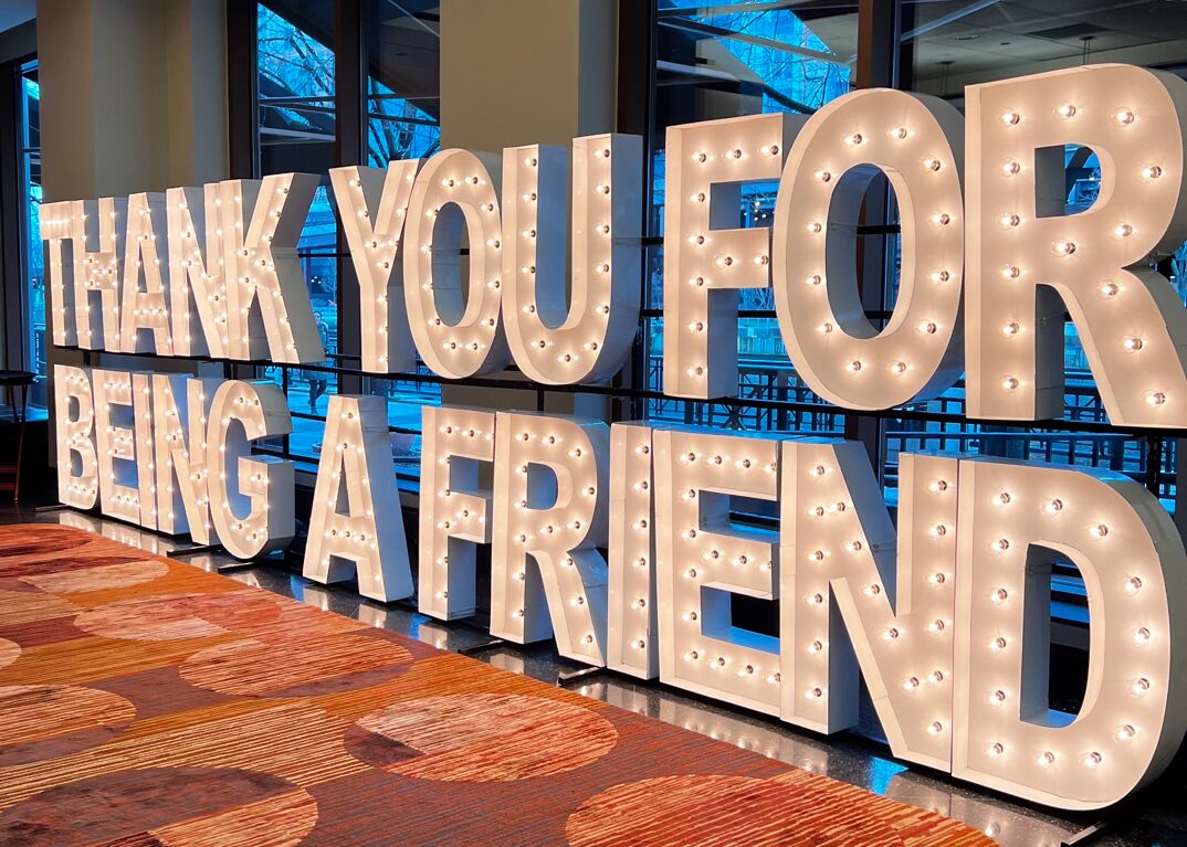 a light-up sign at Golden Con 2023 saying "Thank you for being a friend"