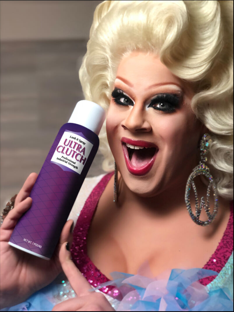 Nina West holds a can of hairspray