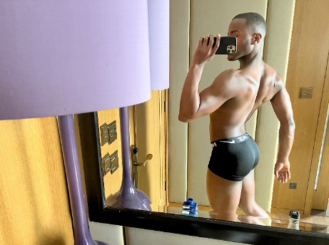 Actor Ncuti Gatwa poses for a mirror photo in the bathroom, showing off his back side in black underwear