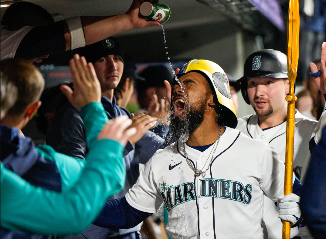 Seattle Mariners player Toescar Hernandez getting doused with water.