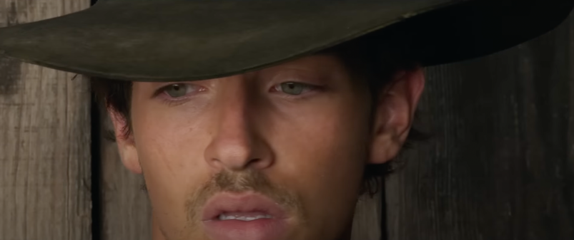 A close-up of Manu Rios wearing a cowboy hat in 'Strange Way of Life'