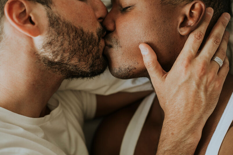 Two men kissing. 
