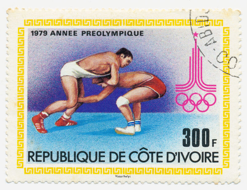 A stamp printed in Ivory Coast shows wrestlers and the symbol Olympiad in Moscow