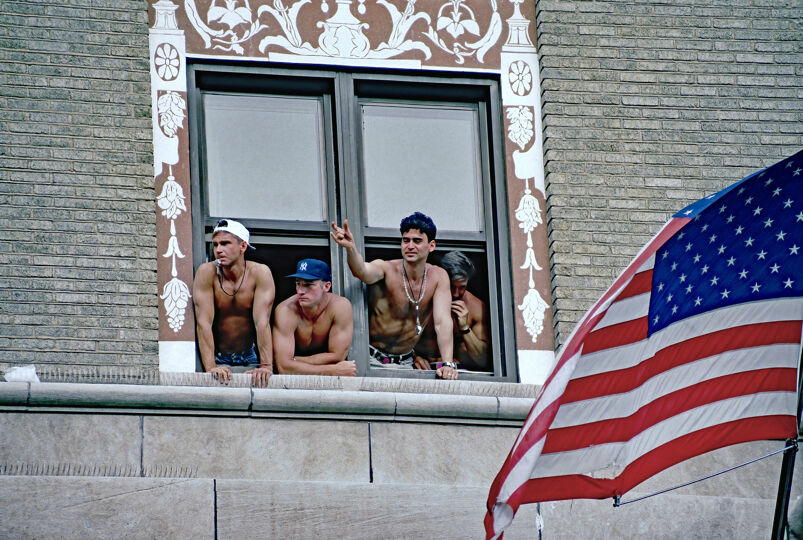 Washington DC, USA, April 25, 1993 Hundreds of thousands of LGBT people march past the White House and down Pennsylvania Ave onto the National Mall group of gay men observe the march from hotel window
