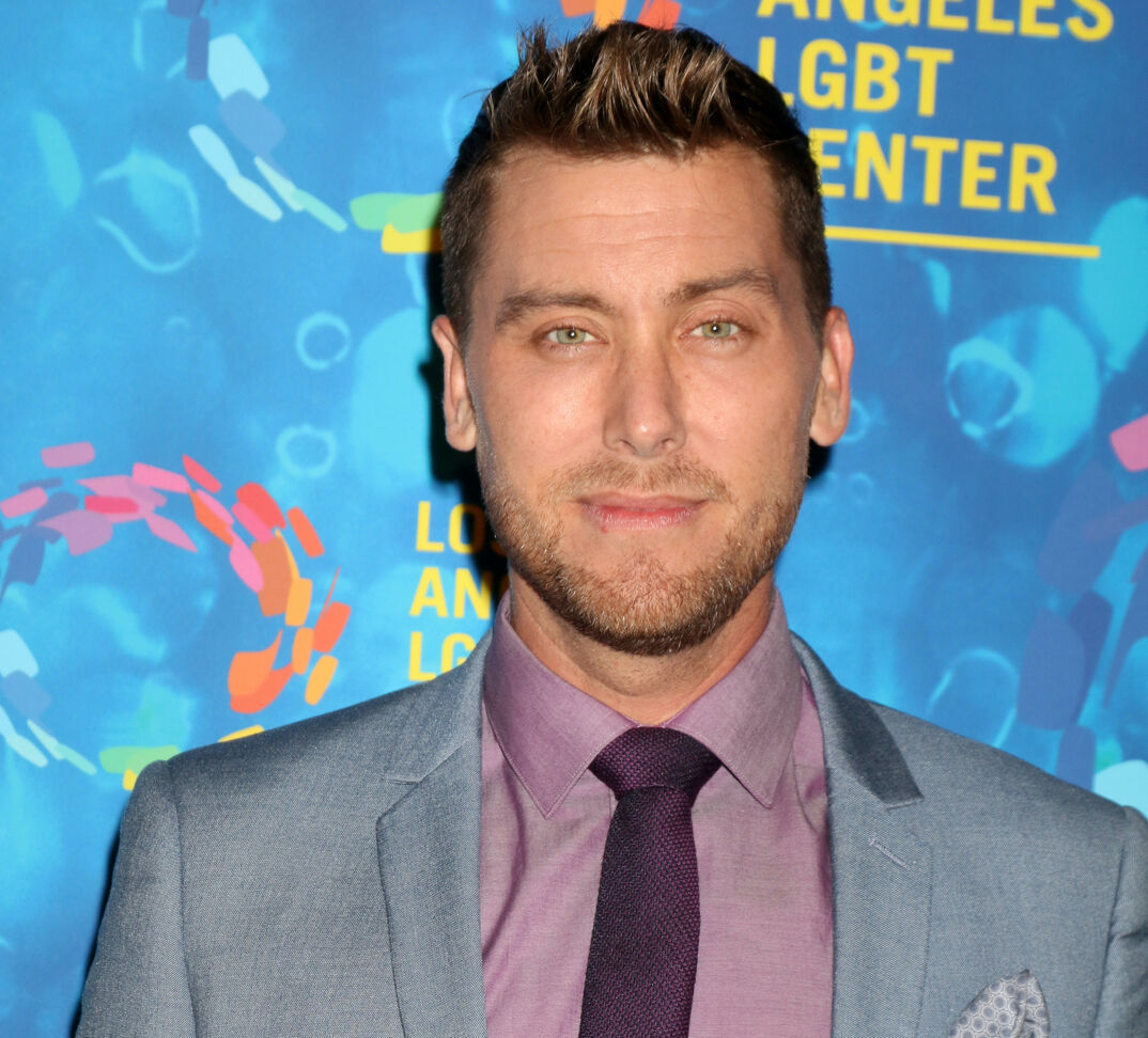 Lance Bass in a grey jacket on the red carpet