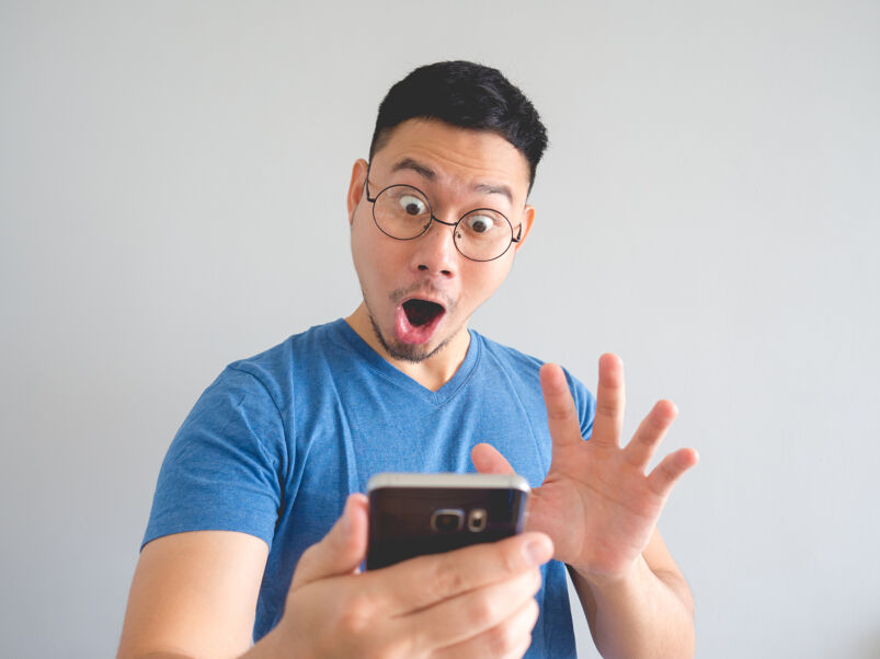 man on cell phone looking surprised