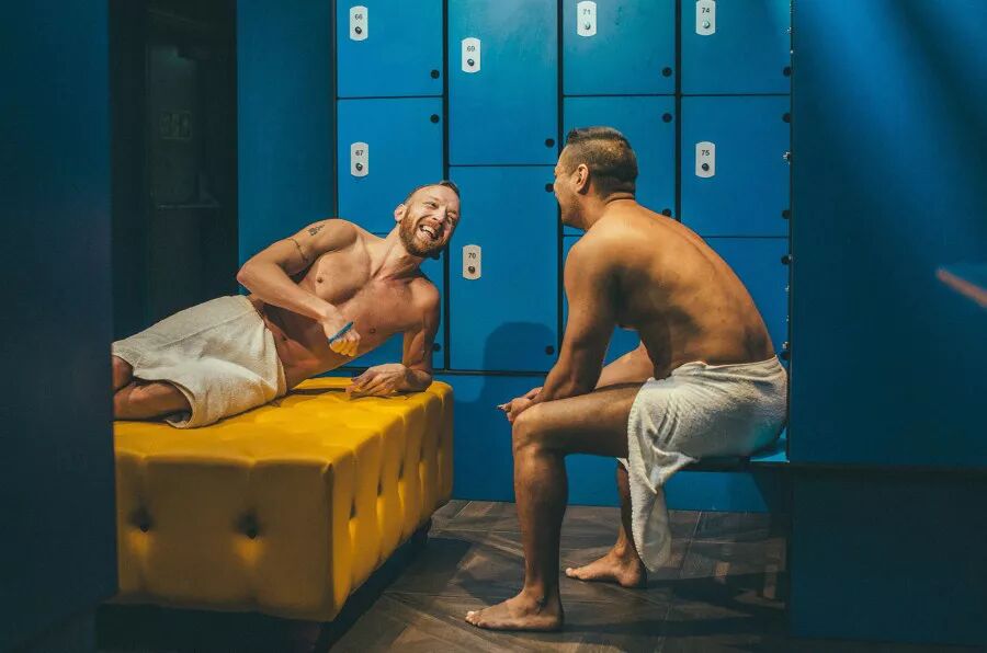 Two men chat in a bathhouse