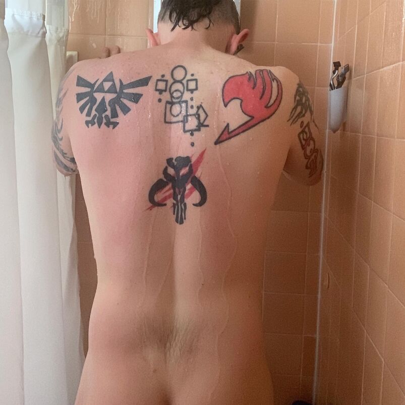 Paul "GayComicGeek" Charles flaunting his Legend of Zelda tattoo during a post-workout shower.