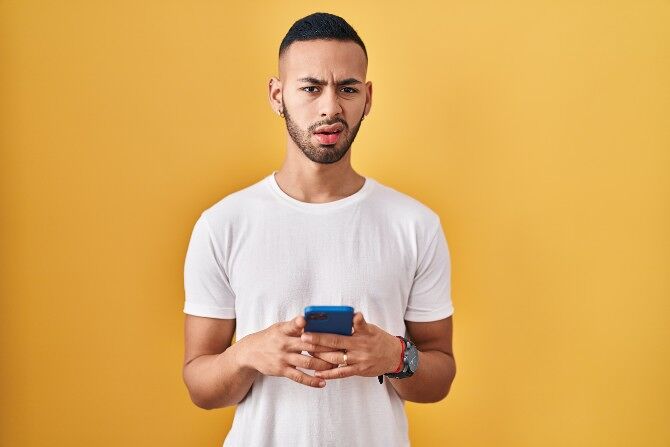 A man is asked to prove he doesn't have Grindr on his phone