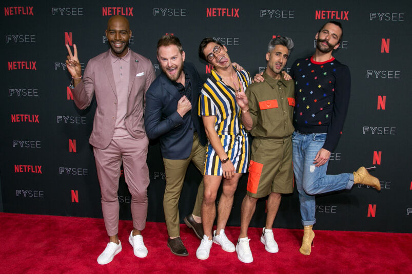 Karamo Brown, Bobby Berk, Antoni Porowski, Tan France, and Jonathan Van Ness make goofy faces while posing on the red carpet at a Netflix event.