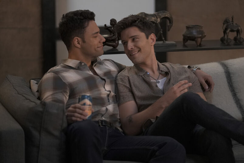 Rafael Silva and Ronen Rubinstein sit on a couch and stare into each other's eyes on Fox drama 9-1-1: Lone Star