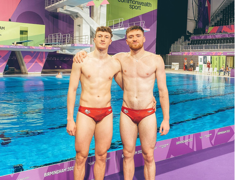 British divers Noah Williams and Matty Lee posing shirtless in red speedos.