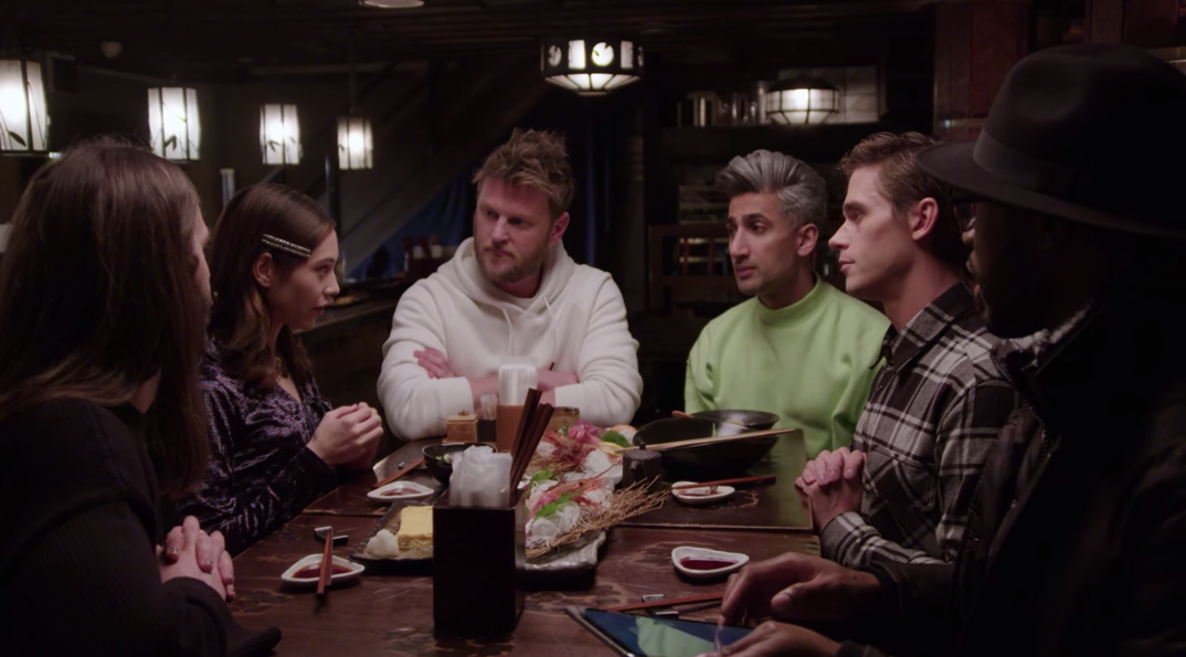 Jonathan Van Ness, Bobby Berk, Tan France, Antoni Porowski, and Karamo Brown listen over a Japanese dinner as a women talks to them about cultural differences in 'Queer Eye: We're in Japan!'
