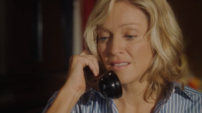 Madonna tearfully holds the phone to her ear in a scene from 'Swept Away.'
