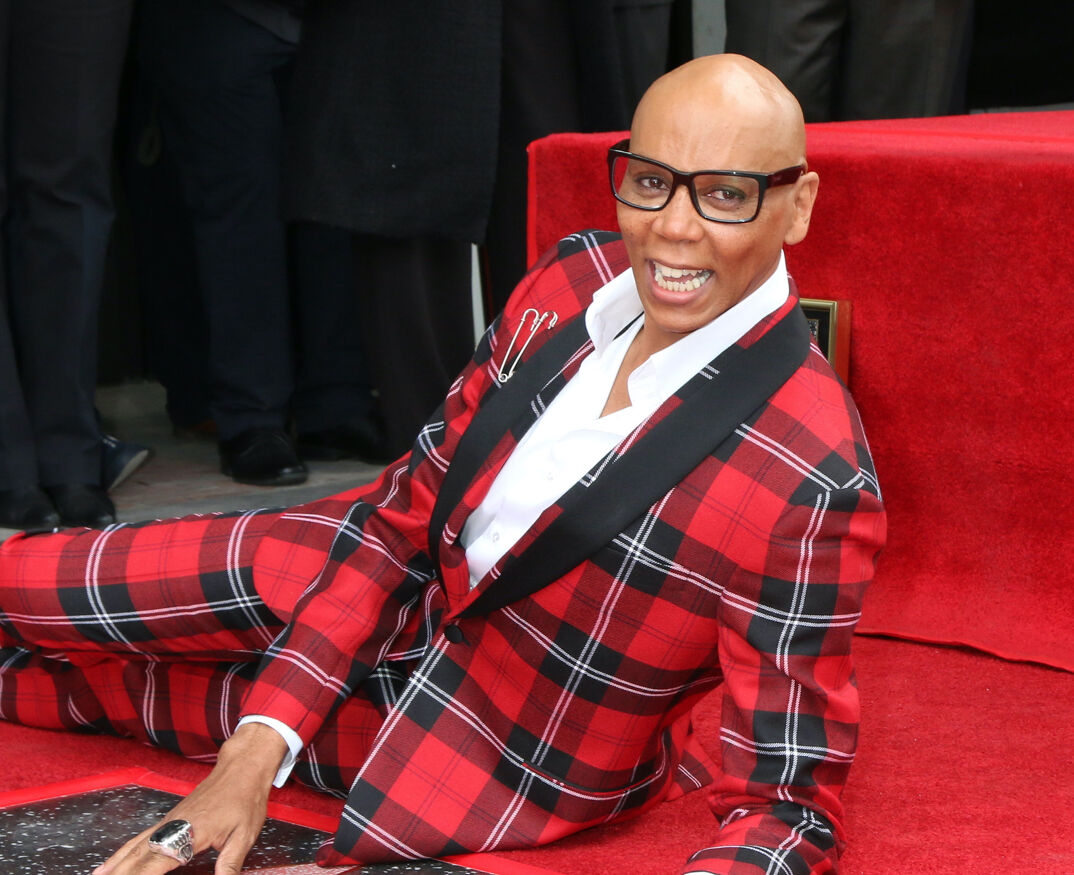 RuPaul in a red plaid suit