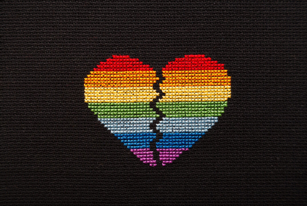 broken rainbow heart embroidered on black yarn