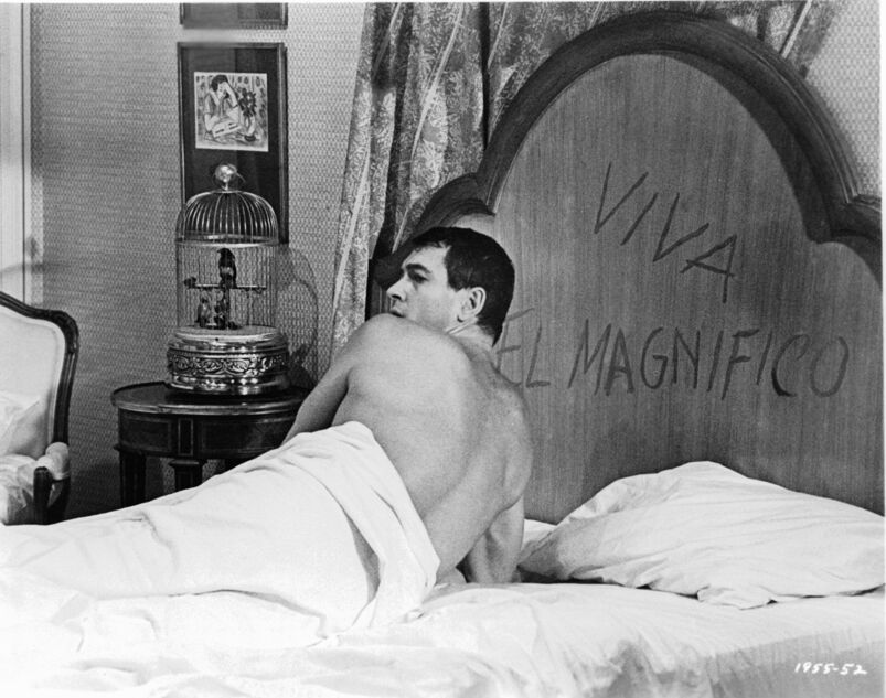 Too much alcohol puts Rock Hudson in a strange and compromising position in a unfamiliar bedroom in a scene from the film 'A Very Special Favor', 1965.