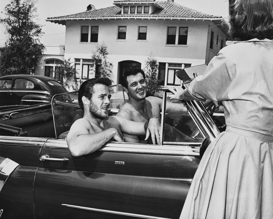 Bob Preble, left, and Rock Hudson, go for a shirtless drive in 1952.