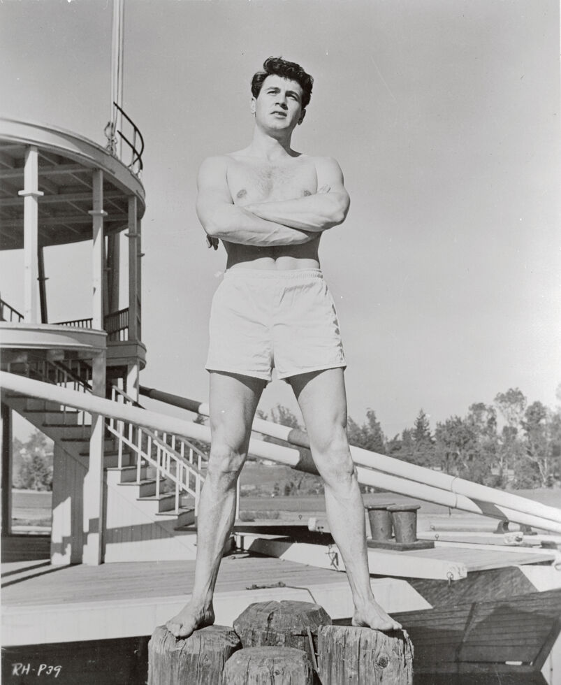 Rock Hudson posing in swimming trunks, 1952.